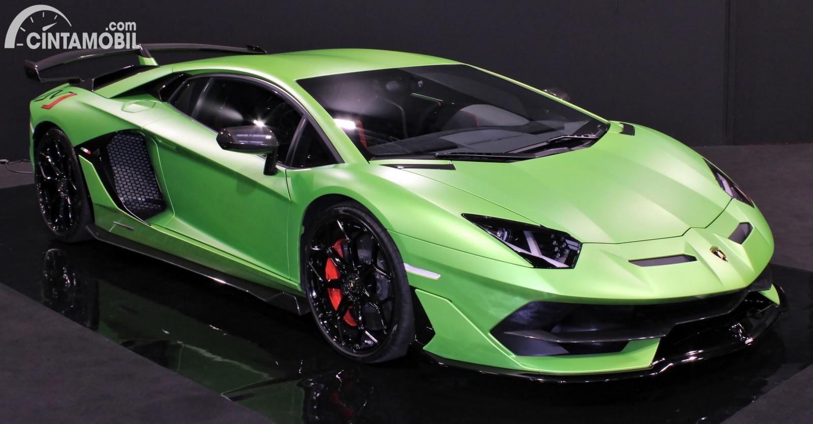 Gambar menunjukkan sebuah mobil Lamborghini Aventador berwarna hijau dilihat dari sisi depan